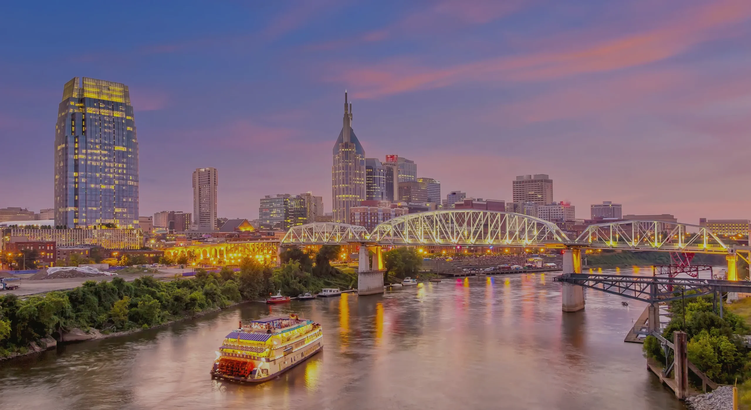 Nashville downtown skyline at golden hour reflected on the Cumberland River
