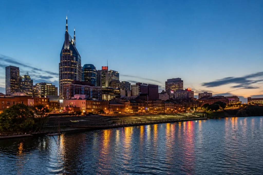 Nashville skyline at blue hour from the Cumberland River waterfront.